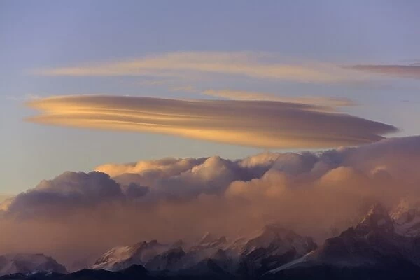 Pink and golden lenticular and cumulus clouds