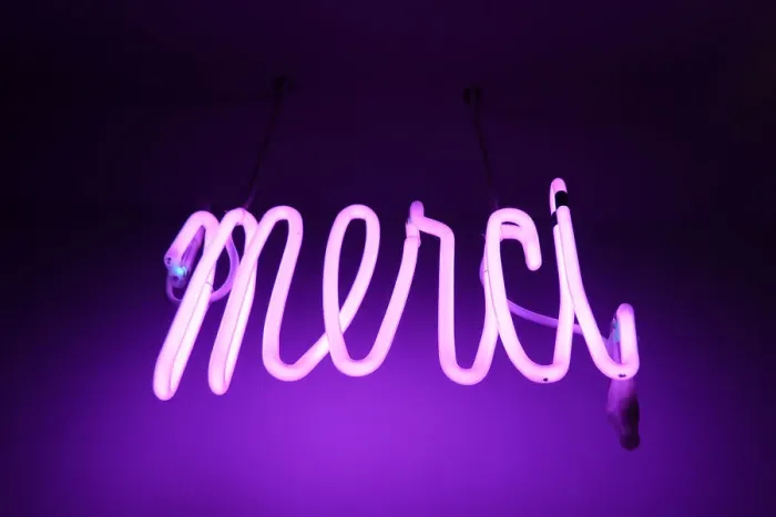 Framed Print : Merci. Pink and purple Neon light sign saying merci (thanks in french) Framed Print : Merci. Pink and purple Neon light sign saying merci (thanks in french)