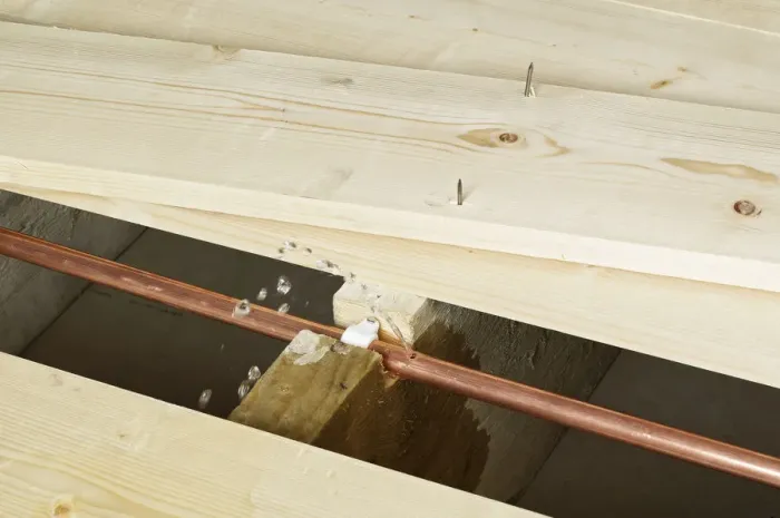 Framed Print : Pipe with hole in exposed under floor boards Framed Print : Pipe with hole in exposed under floor boards