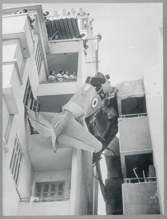 Framed Print : Plane Wreckage Caught Between Buildings