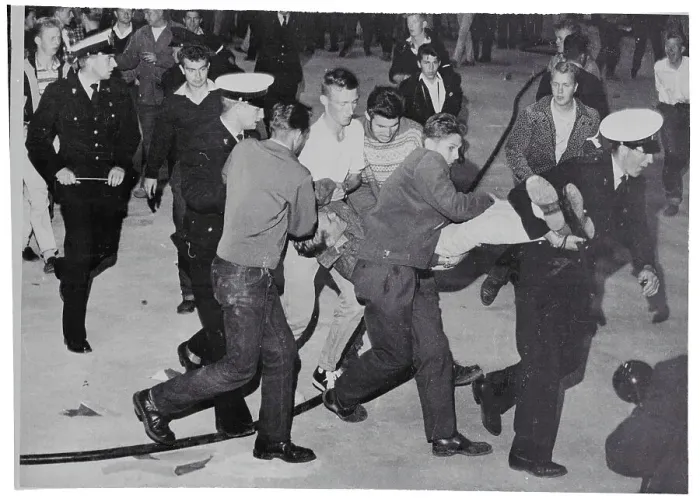 Framed Print : Police Carrying a Resisting Rock and Roll Fan Framed Print : Police Carrying a Resisting Rock and Roll Fan