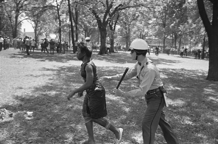 Framed Print : Police Officer Chasing Female Protester Framed Print : Police Officer Chasing Female Protester