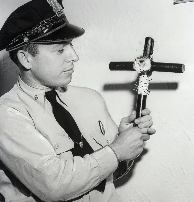 Framed Print : Police Officer Holding Voodoo Cross Framed Print : Police Officer Holding Voodoo Cross