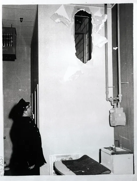 Framed Print : Police Officer Looking at Hole in Wall Framed Print : Police Officer Looking at Hole in Wall