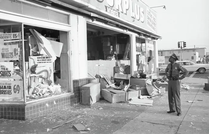 Framed Print : Police Officer Looks Over Damage from Looters Framed Print : Police Officer Looks Over Damage from Looters