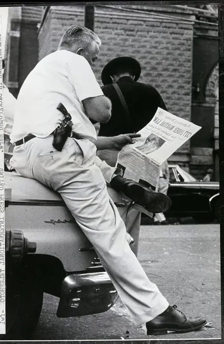 Framed Print : Police Officer Reading Newspaper Framed Print : Police Officer Reading Newspaper