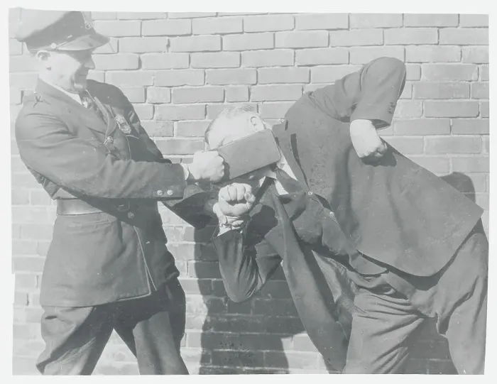 Framed Print : Police Officer Slapping Man in Face