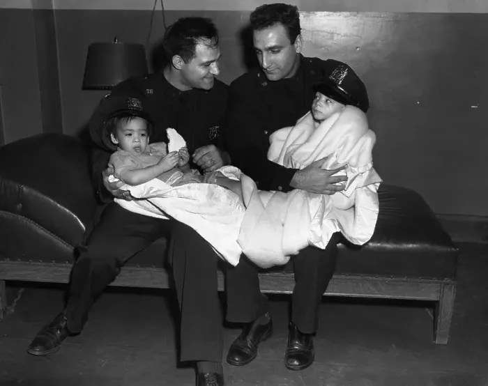 Framed Print : Two Police Officers with Rescued Youngsters Framed Print : Two Police Officers with Rescued Youngsters