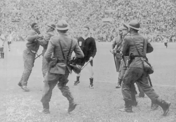 Framed Print : Police Restraining Man During Soccer Game Framed Print : Police Restraining Man During Soccer Game