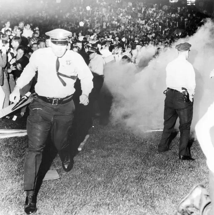 Framed Print : Police Run from Tear Gas at Rolling Stones Show Framed Print : Police Run from Tear Gas at Rolling Stones Show