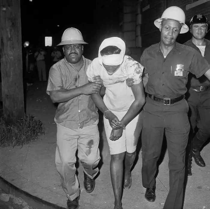 Framed Print : Police Taking Wounded Woman Away Framed Print : Police Taking Wounded Woman Away