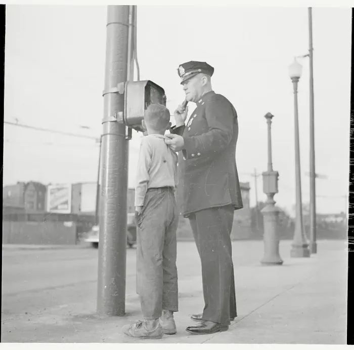 Framed Print : Police Using Telephone with Young Suspect in Tow Framed Print : Police Using Telephone with Young Suspect in Tow