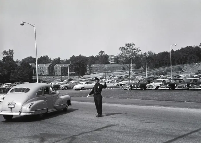 Framed Print : Policeman controlling traffic, parking place behind him Framed Print : Policeman controlling traffic, parking place behind him