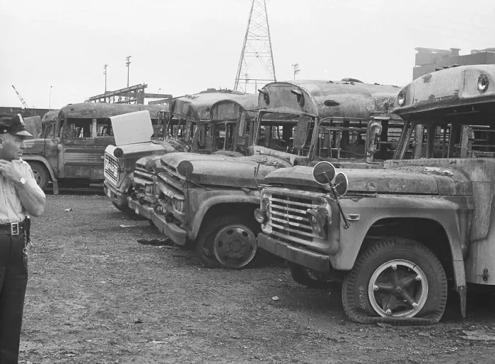 Framed Print : Policeman Examines Burned Buses Framed Print : Policeman Examines Burned Buses