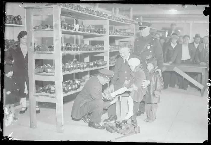 Framed Print : Policeman Fitting Child's Shoe Framed Print : Policeman Fitting Child's Shoe