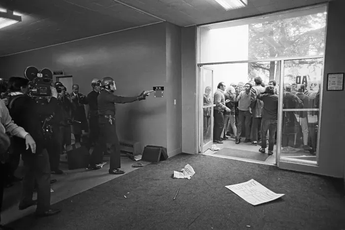 Framed Print : Policeman Points Revolver at Students Framed Print : Policeman Points Revolver at Students