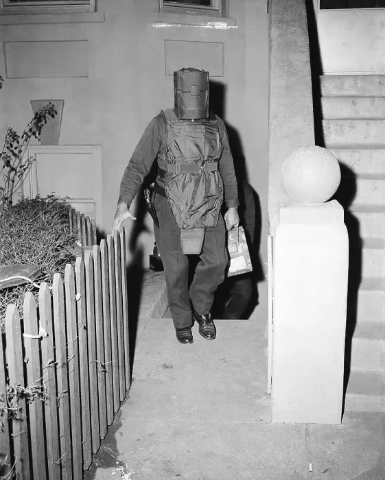 Framed Print : Policeman in Protective Gear Carries Bombs Framed Print : Policeman in Protective Gear Carries Bombs