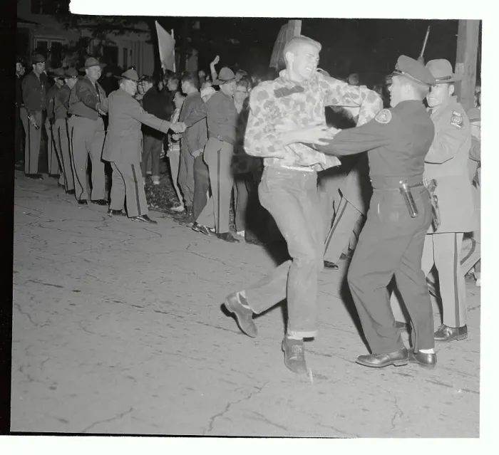 Framed Print : Policeman Restraining a Protester Framed Print : Policeman Restraining a Protester