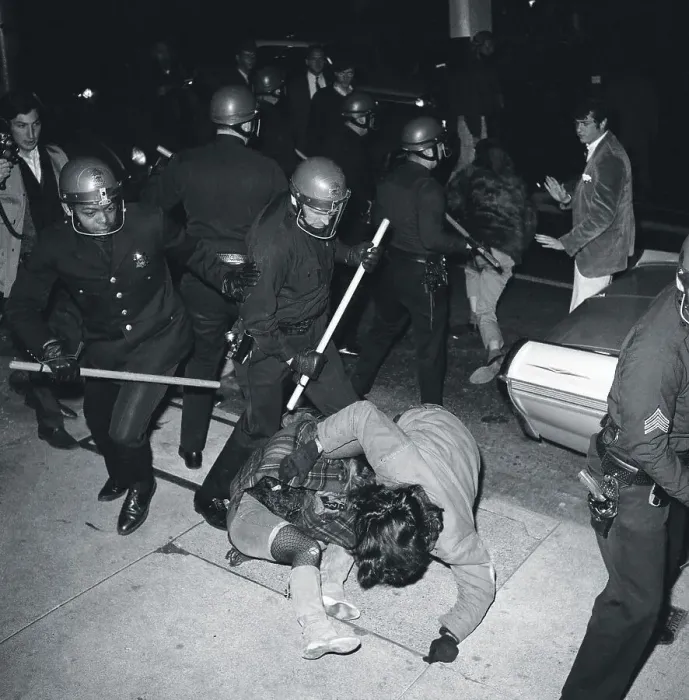 Framed Print : Policeman with Sticks Beating Protesters Framed Print : Policeman with Sticks Beating Protesters