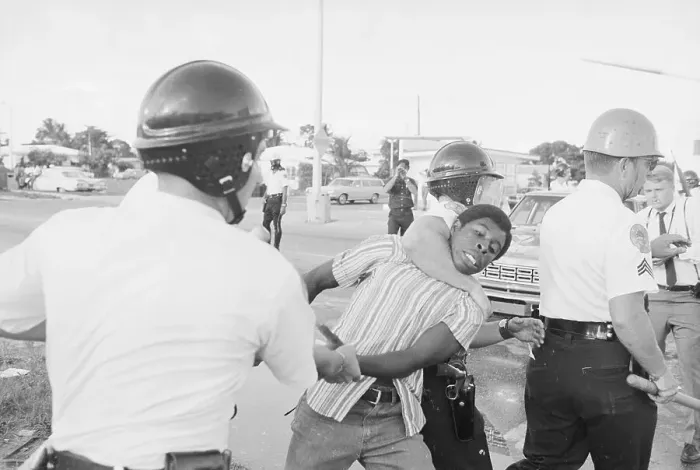 Framed Print : Policemen Choking African American Rioter