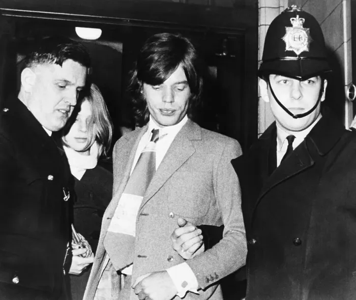 Framed Print : Policemen Escorting Mick Jagger and Girlfriend Framed Print : Policemen Escorting Mick Jagger and Girlfriend