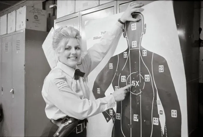 Framed Print : Policewoman Pointing out Target for Firearms Training Framed Print : Policewoman Pointing out Target for Firearms Training