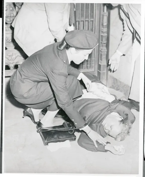 Framed Print : Policewoman Trying to Revive a Fainted Woman Framed Print : Policewoman Trying to Revive a Fainted Woman