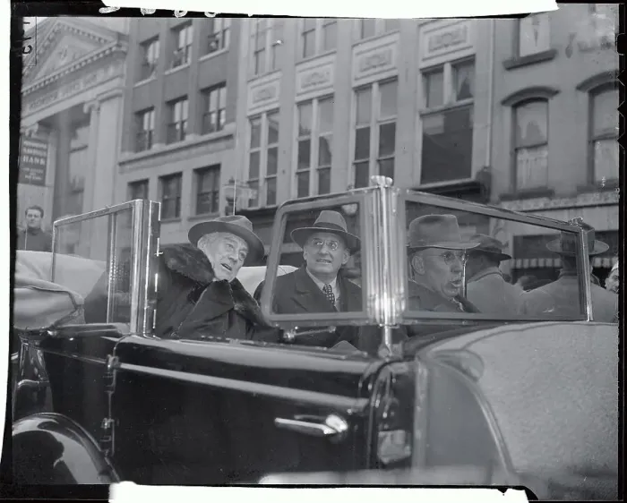 Framed Print : Politicians Riding Past Building in Car Framed Print : Politicians Riding Past Building in Car