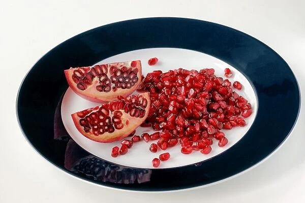 Pomegranate pieces and seeds on a plate