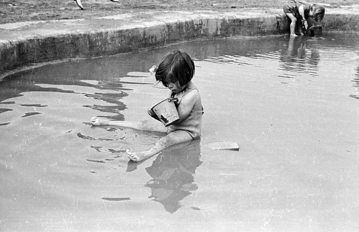 Framed Print : Pond Life. 13th July 1946: A young holidaymaker sitting in a pond at the Framed Print : Pond Life. 13th July 1946: A young holidaymaker sitting in a pond at the