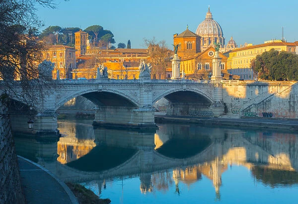 Ponte Vittorio Emmanual II over the Tiber river in Rome, in the background the dome of St. Peter Basilica
