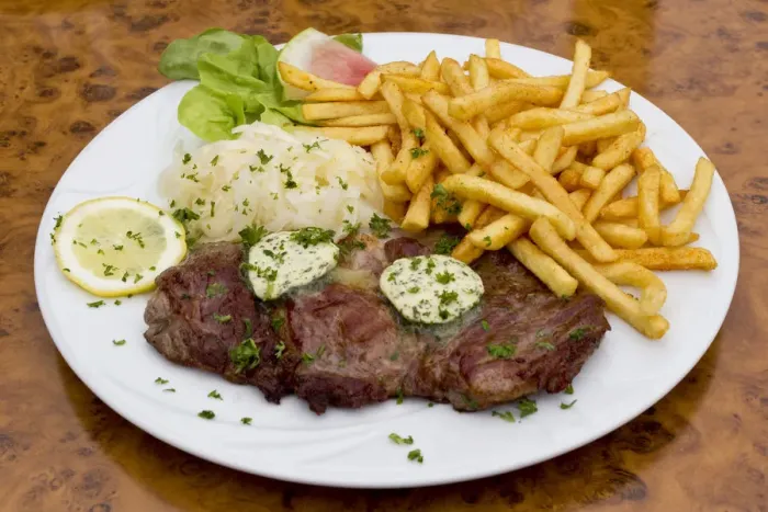 Framed Print : Pork neck steaks with coleslaw, herb butter and fries Framed Print : Pork neck steaks with coleslaw, herb butter and fries