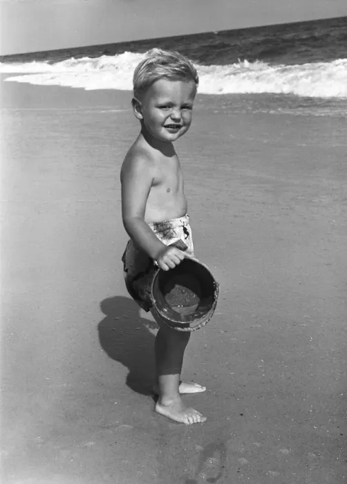 Framed Print : Portrait of boy (4-5) at seashore with bucket Framed Print : Portrait of boy (4-5) at seashore with bucket