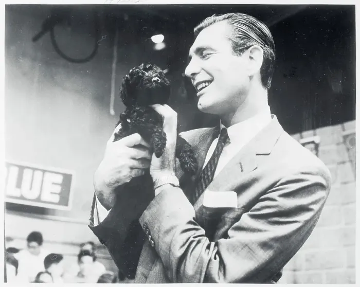 : Portrait of Emcee Sonny Fox Holding Dog : Portrait of Emcee Sonny Fox Holding Dog