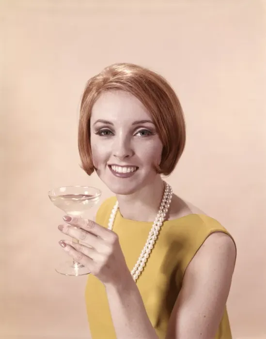 Framed Print : Portrait of glamorous woman in pearls holding cocktail Framed Print : Portrait of glamorous woman in pearls holding cocktail