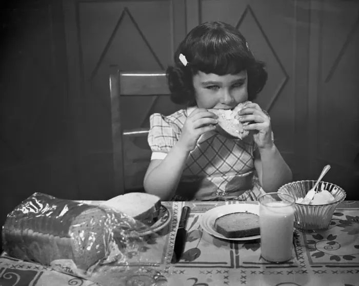 Framed Print : Portrait of little girl eating buttered toast Framed Print : Portrait of little girl eating buttered toast