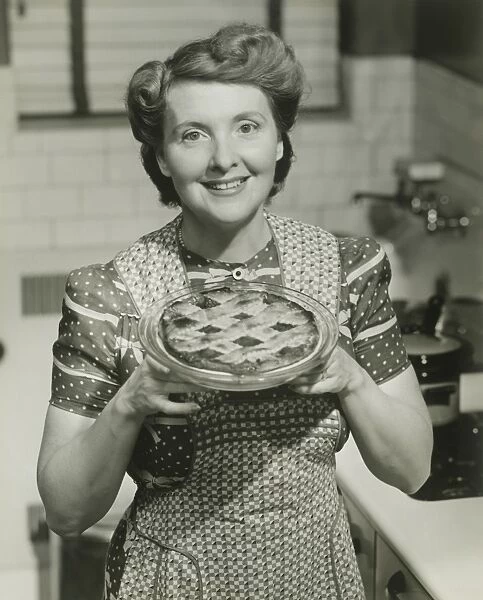 Portrait of mature woman holding pie