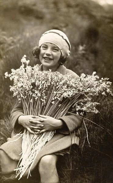 Portrait of a Smiling Girl Holding a Bunch of Flowers