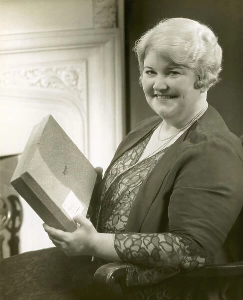 Portrait of a woman holding box