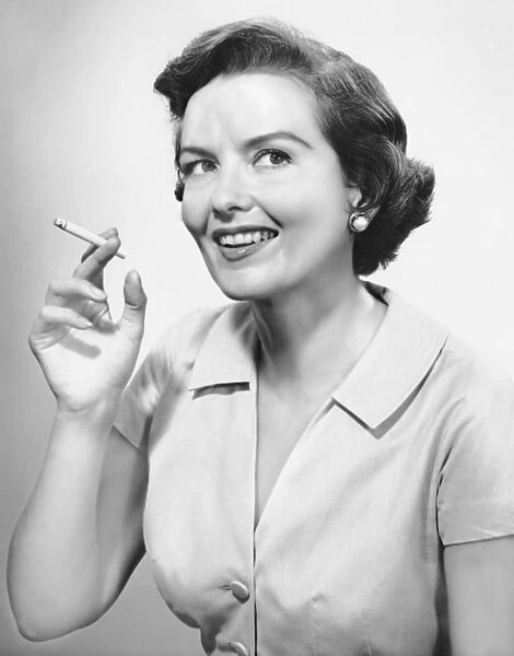 Portrait of woman holding cigarettte