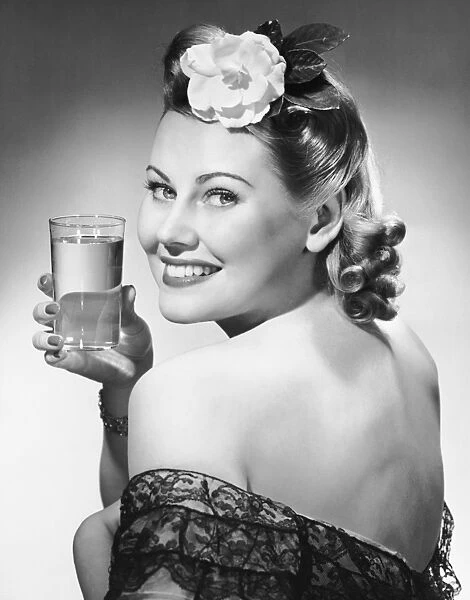 Portrait of woman holding glass of water