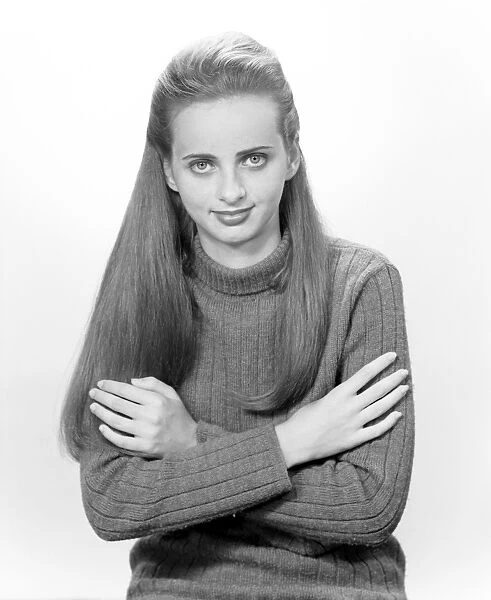 Portrait of young woman with arms crossed