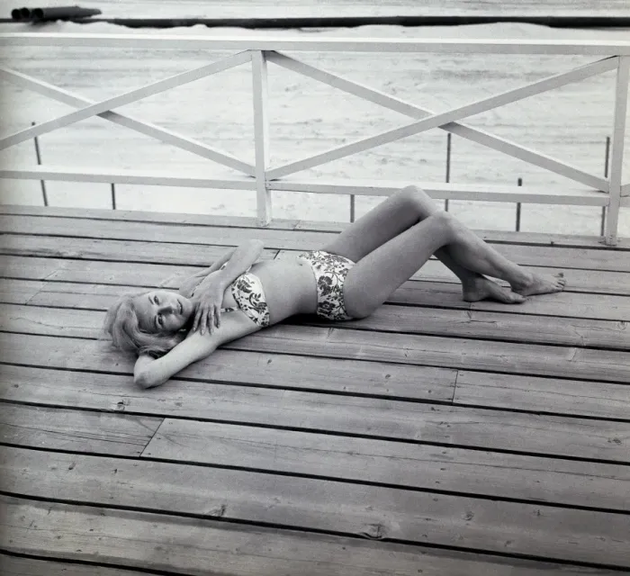 Framed Print : Portrait of young woman in bikini lying on deck Framed Print : Portrait of young woman in bikini lying on deck