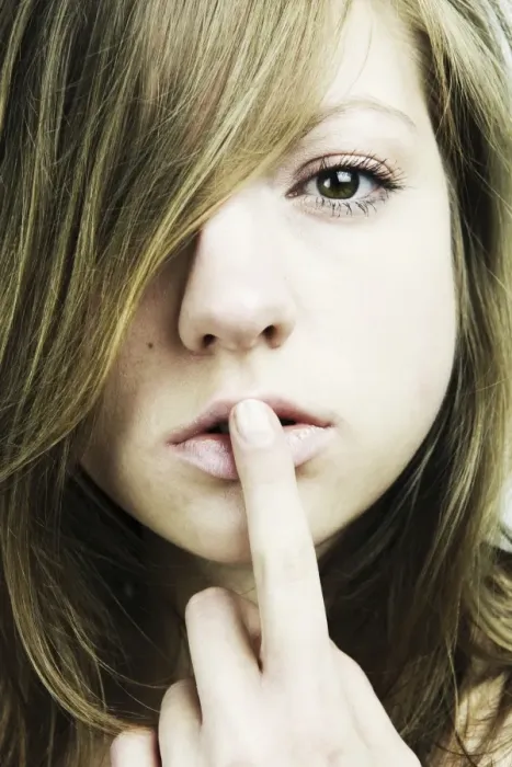 Framed Print : Portrait of a young woman with long hair, finger on her mouth Framed Print : Portrait of a young woman with long hair, finger on her mouth
