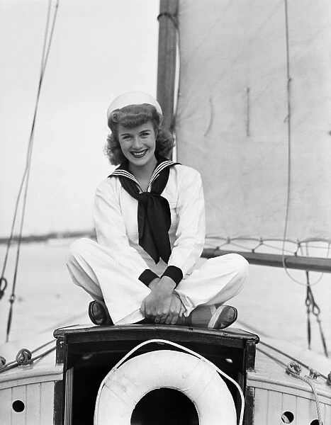 Portrait of young woman in sailor suit on ship