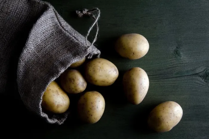 Framed Print : Potatoes in burlap sack on wood Framed Print : Potatoes in burlap sack on wood