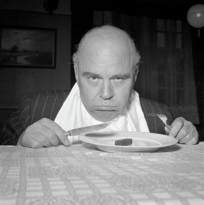 Framed Print : Pouting Man with Tiny Breakfast Framed Print : Pouting Man with Tiny Breakfast