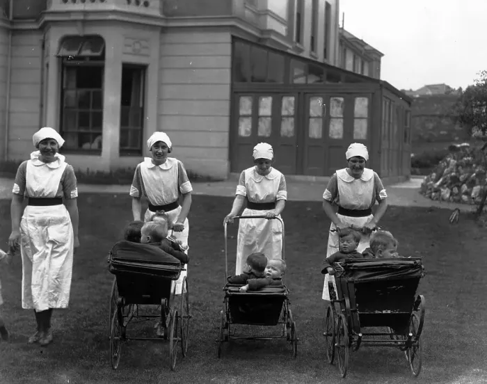 Framed Print : Pram Ride. 1926: A group of nurses stroll with their young charges Framed Print : Pram Ride. 1926: A group of nurses stroll with their young charges