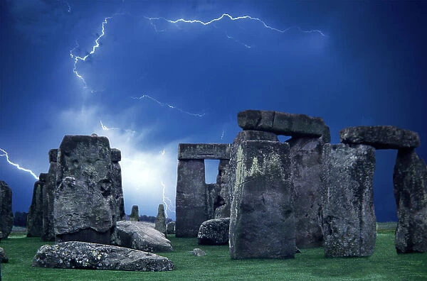 The prehistoric Stonehenge Monument on the Salisbury Plain, UK with time-exposure of lightning