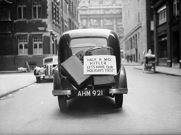 Priority. 28th August 1939: A car with luggage strapped to its boot carries